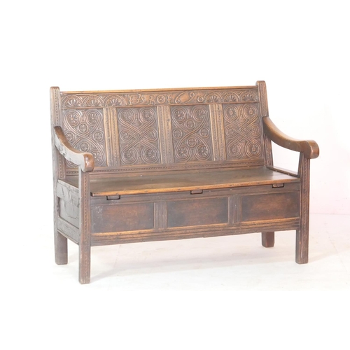 559 - Oak joined box settle, 19th Century, guilloche carved four panel back with a frieze carved with init... 