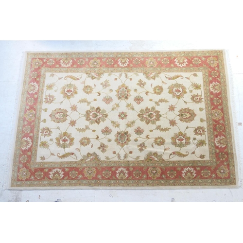 569 - Iranian Zeigler woollen carpet, ivory field dispersed with madder palmettes and a madder palmette bo... 