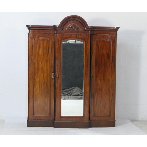 575 - Victorian mahogany breakfront wardrobe, circa 1870, having a carved and arched ogee moulded cornice ... 