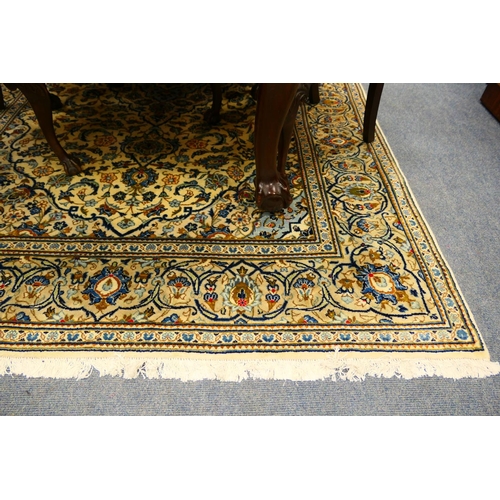 548 - Kashan woollen carpet, having a fawn field with a sky blue central medallion dispersed with palmette... 