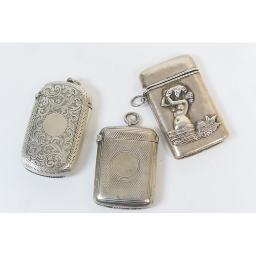 172 - Three silver vesta cases, comprising one of cushion form with scroll engraved decoration and vacant ... 