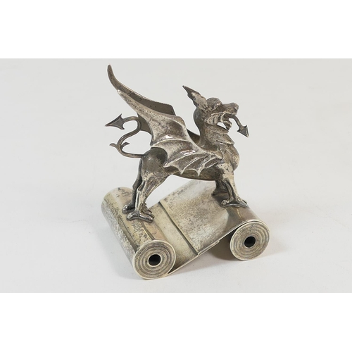 179 - Welsh interest: Silver dragon form paperweight, the dragon standing astride two paper scrolls, by Th... 