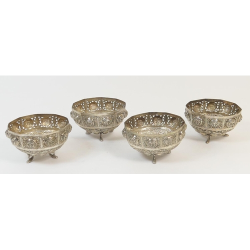 186 - Four Indian white metal small bowls, late 19th Century, each with a pierced border punctuated with m... 