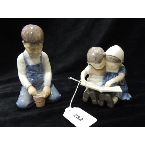 282 - Two Danish figurines, one a child seated the other of children studying