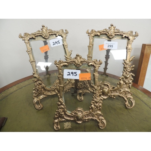 295 - Three brass foliate picture stands