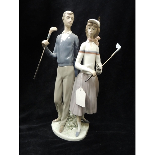 284 - Large Lladro figurine of a couple playing golf, imprinted on base with 'F-91'