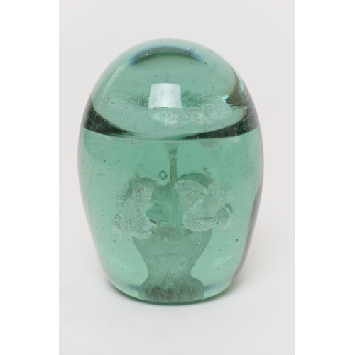 8 - Four Nailsea glass dumps, 19th Century, comprising a bun form with random air bubbles to the centre,... 
