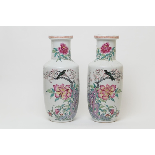 85 - Pair of Chinese famille rose rouleau vases, 18th or 19th Century, decorated with birds seated amidst... 