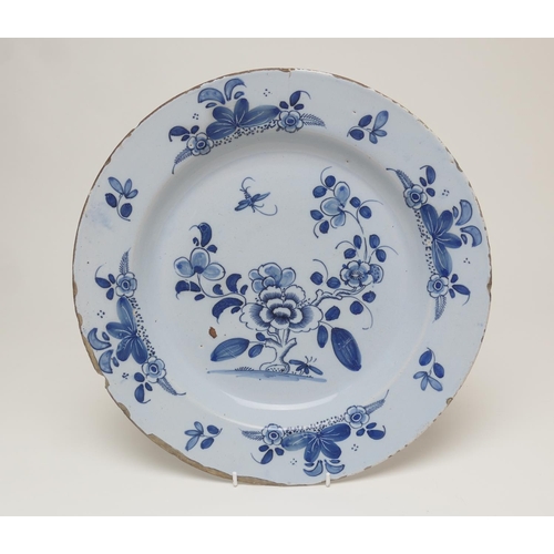 89 - English delft blue and white charger, circa 1740, decorated after the Chinese with a central peony r... 