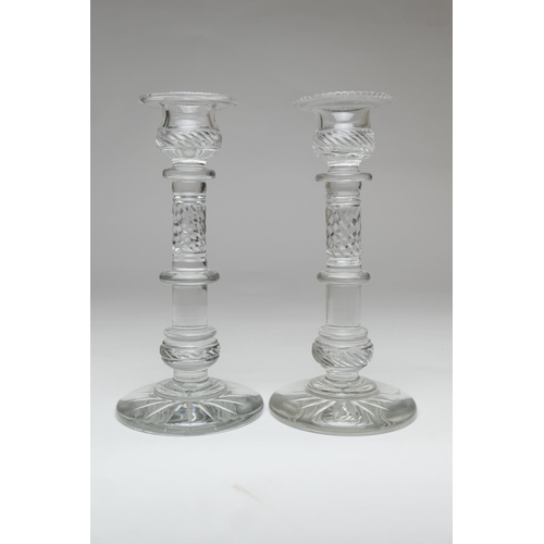 90 - Pair of quality cut glass candlesticks, having multi-knopped columns with wrythen slice cuts, over a... 