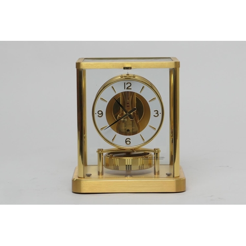 667 - Jaeger Le Coultre brass Atmos clock, mid 1970s, having a white chapter ring with Arabic and baton nu... 