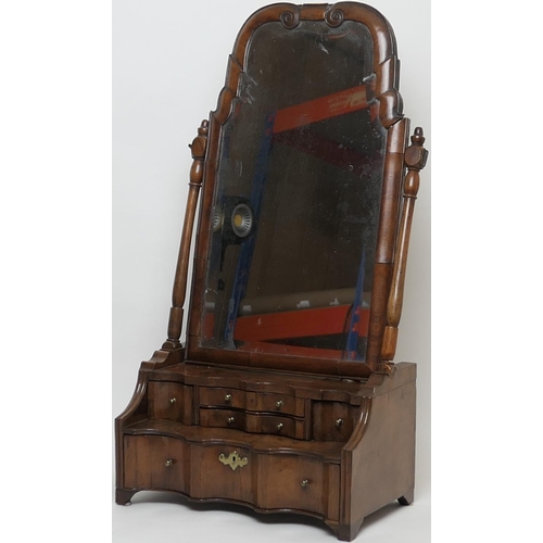 688 - Walnut dressing mirror, early 18th Century, having a shaped bevelled glass plate within a cushion mo... 