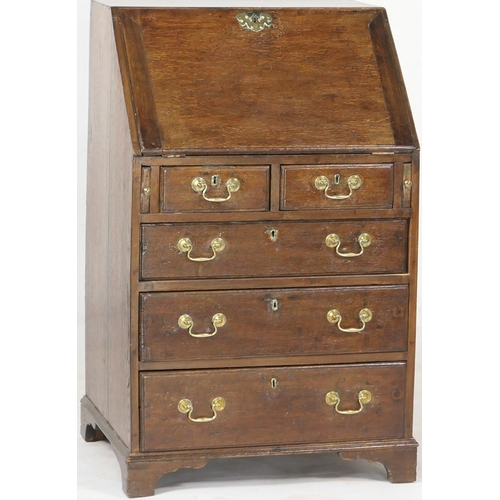 697 - Small oak bureau, 19th Century conversion, having a slope front opening to an interior with cupboard... 