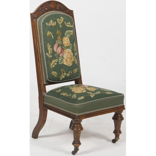 699 - Victorian carved walnut and needlework upholstered nursing chair, circa 1870, having an arched back ... 