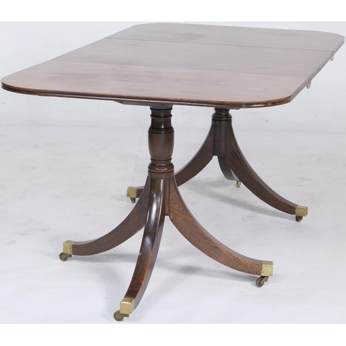 703 - Regency mahogany twin pedestal dining table of small proportions, having D-ends accommodating one ex... 