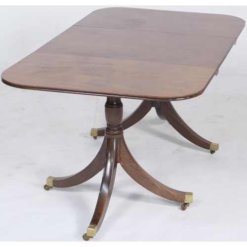 703 - Regency mahogany twin pedestal dining table of small proportions, having D-ends accommodating one ex... 