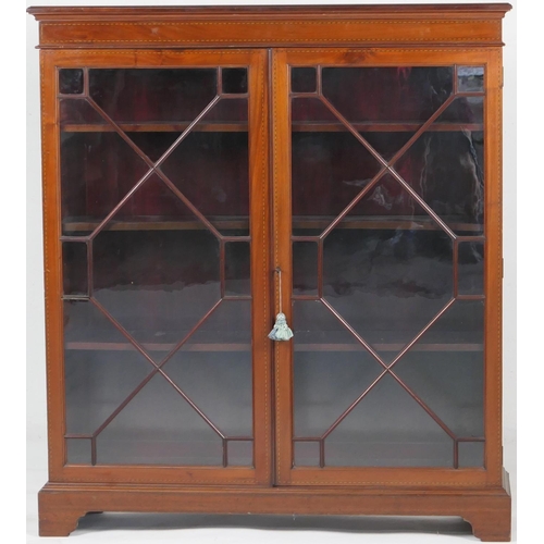 729 - Late Victorian mahogany and inlaid glazed bookcase, having boxwood and ebony stringing throughout, a... 