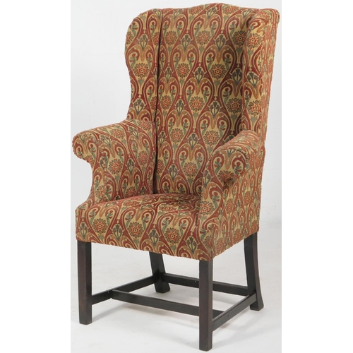 775 - Upholstered wing armchair in Georgian style, upholstered throughout in a moquette style tapestry fab... 