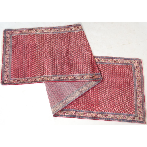 777 - Araak red ground woollen runner, the field dispersed with myriad of small botehs, size 431cm x 109cm