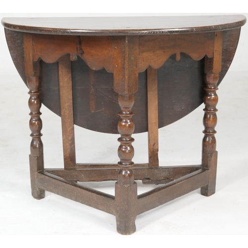 788 - Oak joined credence table, demi-lune form with a single drop leaf, on a triform base with a single g... 