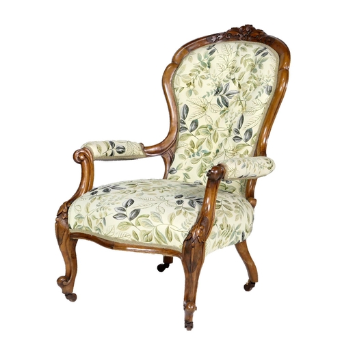 724 - Victorian walnut and upholstered spoonback armchair, circa 1860, with carved cresting rail, deep but... 