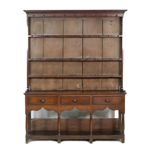 747 - Late George III oak dresser and plate rack, circa 1800, the boarded rack with three shelves and thre... 