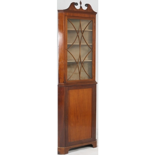 705 - Mahogany glazed freestanding corner cabinet, 19th Century, having a swan neck pediment centred with ... 