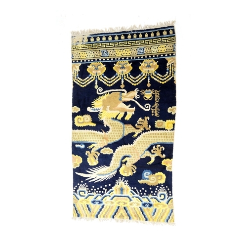 709 - Traditional Chinese woollen pillar rug, 19th Century, having a five toed dragon clutching a flaming ... 