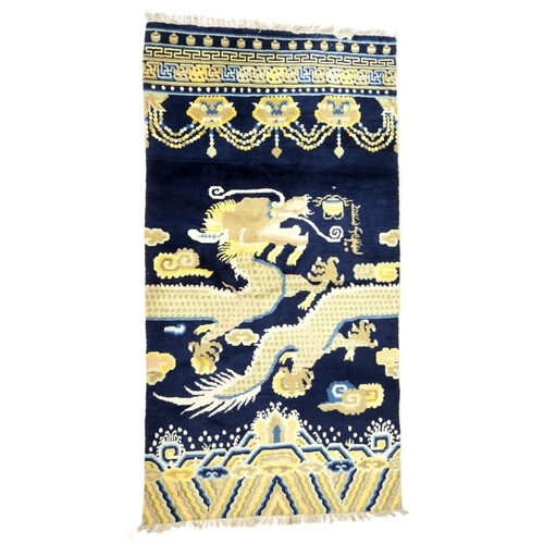 710 - Traditional Chinese woollen pillar rug, 19th Century, having a five toed dragon clutching a flaming ... 