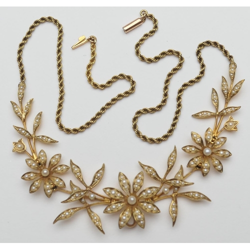 383 - Late Victorian 15ct gold pearl floral necklace, circa 1900, having three flowerheads inset with spli... 