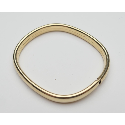 385 - Continental 9ct gold hollow bangle, London import marks for 1986, interior size 6cm, weight approx. ... 