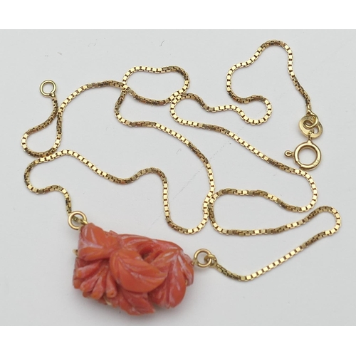 387 - Carved coral pendant necklace, the coral carved with leaves, suspended from an 18ct gold boxlink nec... 