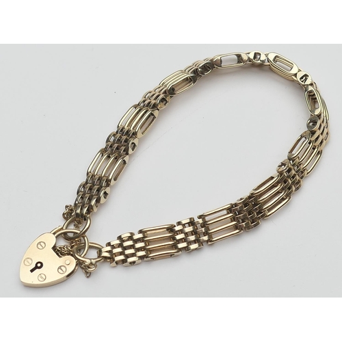 411 - 9ct gold gatelink bracelet, with padlock clasp and safety chain, length 16.5cm, weight approx. 15.4g