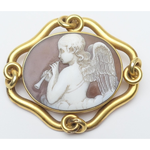 424 - Victorian carved shell cameo brooch, circa 1870, carved with an angel playing a pipe amidst clouds, ... 