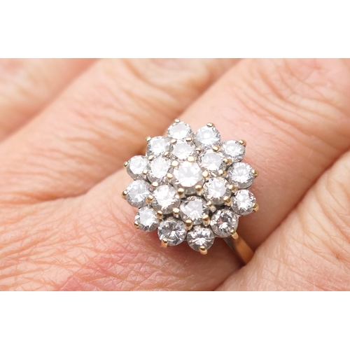 430 - Diamond cluster ring, set with 19 round brilliant cut stones, in a flowerhead stepped 18ct white gol... 