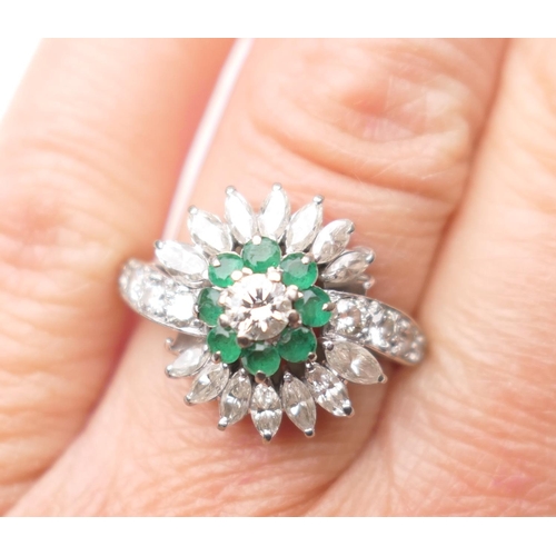 432 - Emerald and diamond cluster ring, central round brilliant cut diamond of approx. 0.25ct, bordered wi... 