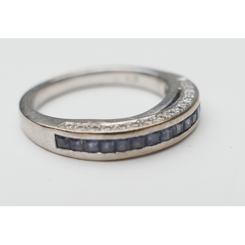 433 - Sapphire and diamond half eternity ring, in 18ct white gold, channel set with 16 cushion cut pale sa... 