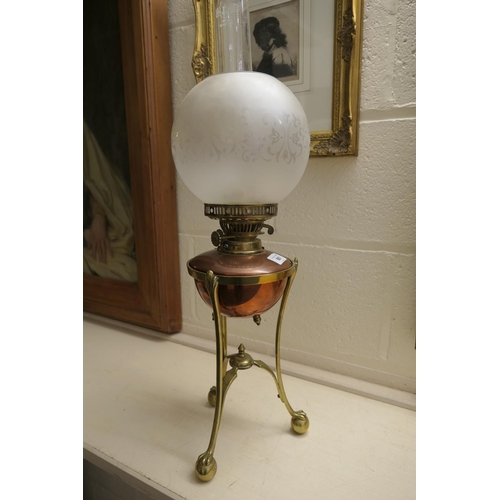 661 - W.A.S. Benson, brass and copper oil lamp, with a frosted spherical shade, copper tank over a brass t... 