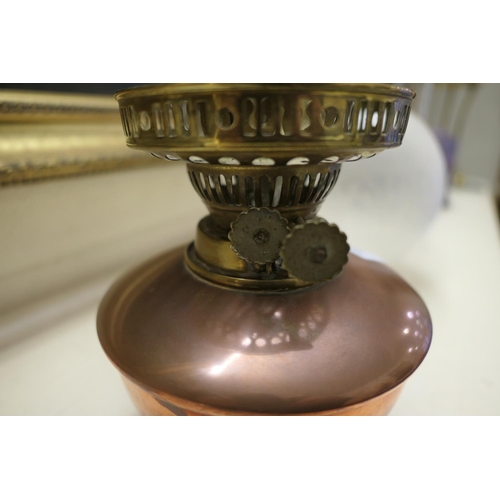 661 - W.A.S. Benson, brass and copper oil lamp, with a frosted spherical shade, copper tank over a brass t... 