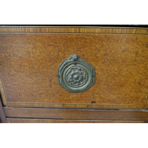 712 - French walnut and satinwood commode, 19th Century, the crossbanded satinwood top 
over three long dr... 