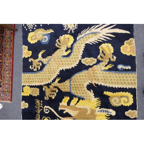 709 - Traditional Chinese woollen pillar rug, 19th Century, having a five toed dragon clutching a flaming ... 