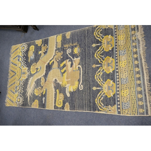 710 - Traditional Chinese woollen pillar rug, 19th Century, having a five toed dragon clutching a flaming ... 