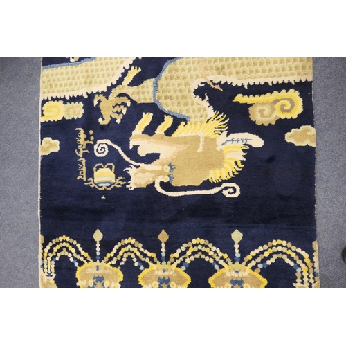 710 - Traditional Chinese woollen pillar rug, 19th Century, having a five toed dragon clutching a flaming ... 