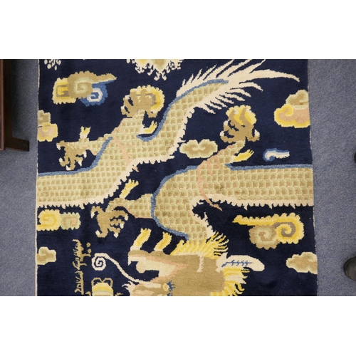 710 - Traditional Chinese woollen pillar rug, 19th Century, having a five toed dragon clutching a flaming ... 