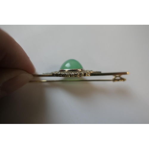 419 - Jade and diamond bar brooch, the celadon green cabochon bordered with rose cut diamonds set in white... 