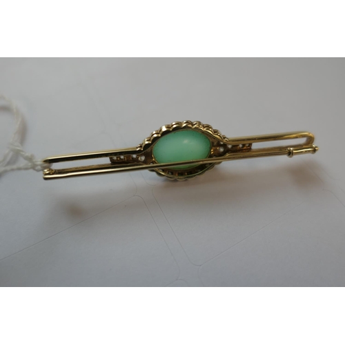 419 - Jade and diamond bar brooch, the celadon green cabochon bordered with rose cut diamonds set in white... 