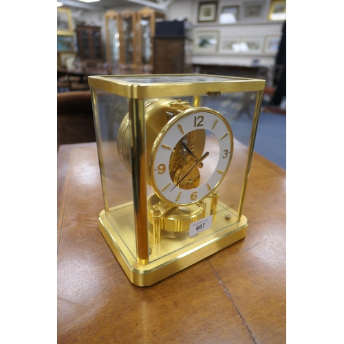 667 - Jaeger Le Coultre brass Atmos clock, mid 1970s, having a white chapter ring with Arabic and baton nu... 