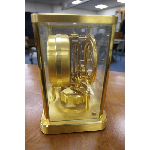 667 - Jaeger Le Coultre brass Atmos clock, mid 1970s, having a white chapter ring with Arabic and baton nu... 