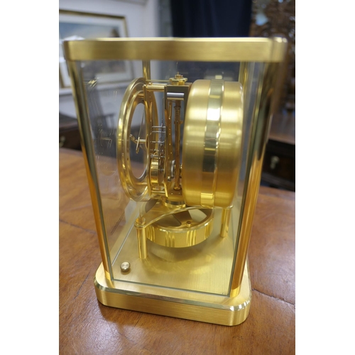 667 - Jaeger Le Coultre brass Atmos clock, mid 1970s, having a white chapter ring with Arabic and baton nu... 