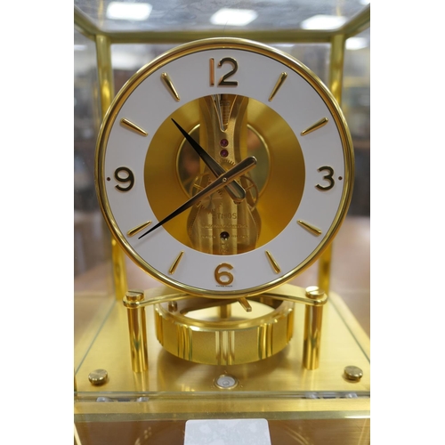 667 - Jaeger Le Coultre brass Atmos clock, mid 1970s, having a white chapter ring with Arabic and baton nu... 